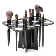 Luckyrien nail and makeup brushes drying on clear acrylic rack in a studio.