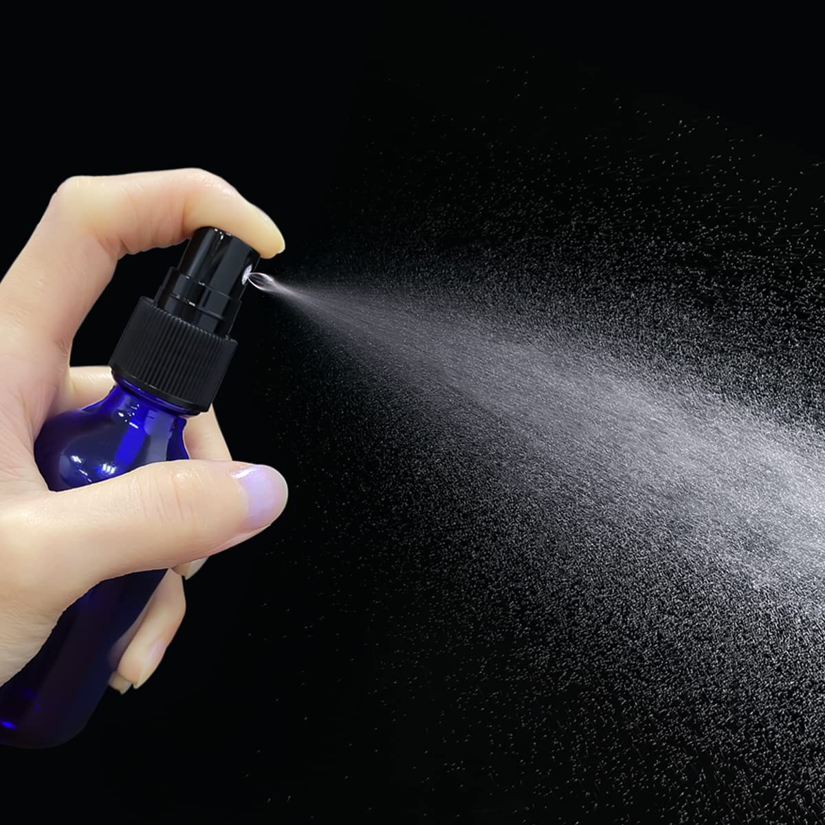 LUFEVRM 2oz blue glass spray bottle back view, compact storage for cosmetics.