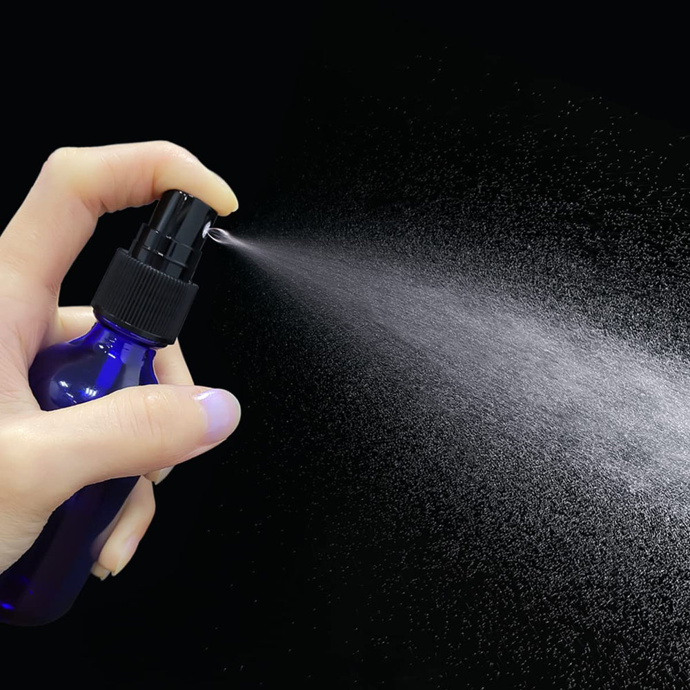 LUFEVRM 2oz blue glass spray bottle back view, compact storage for cosmetics.