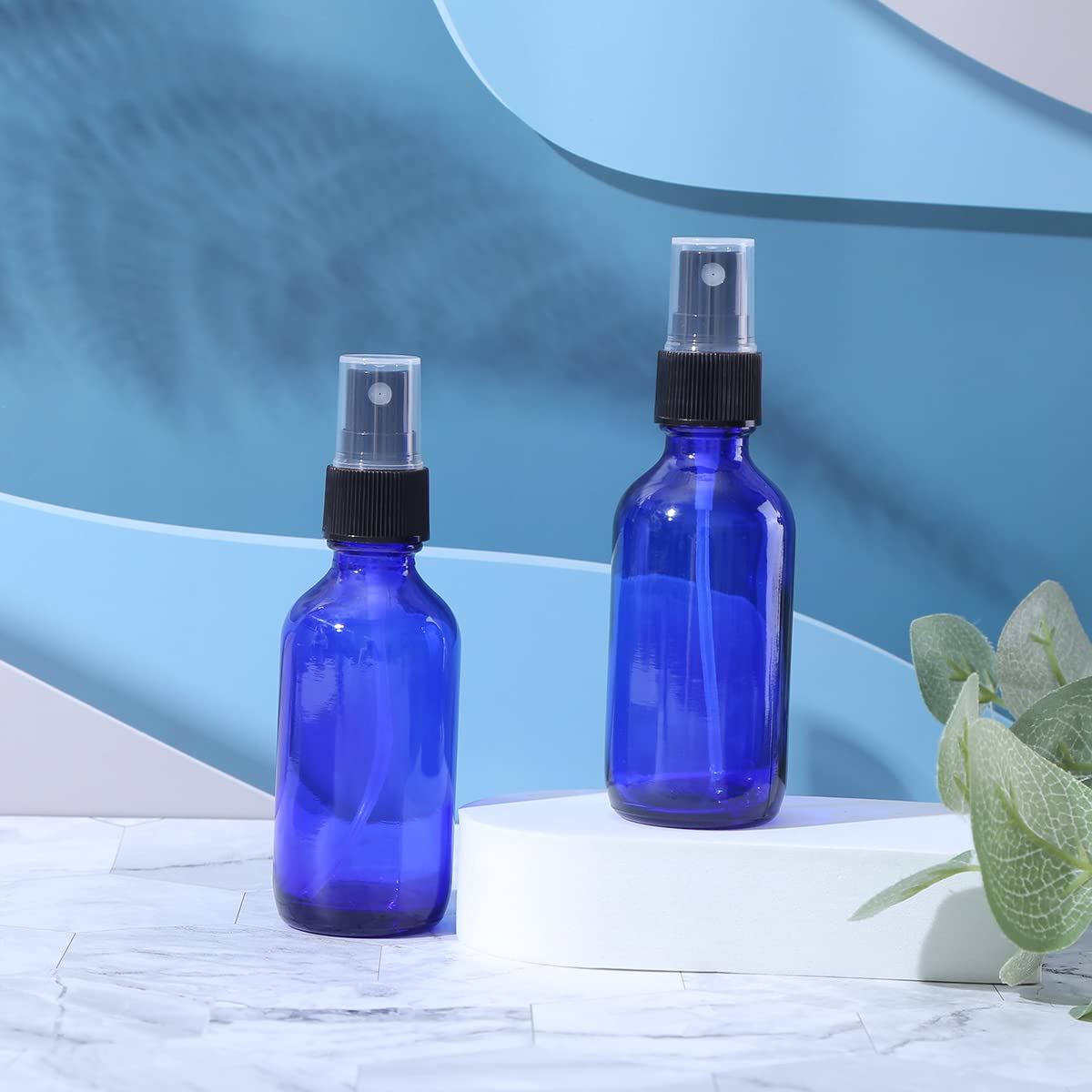 LUFEVRM 2oz blue glass spray bottle nozzle detail, precise fine mist.