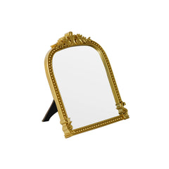 LuHeToz Gold Arched Mirror on a dresser adds vintage charm and practical reflection.