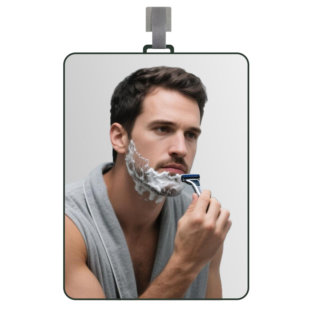 LUNCHIS fogless shower mirror shows a clear shaving reflection in a steamy bathroom