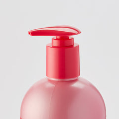 Hands apply Luster's Pink Oil Moisturizer to hair lengths for nourishment.