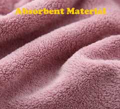 M-bestl turban-style hair wrap with button close-up securing hair.