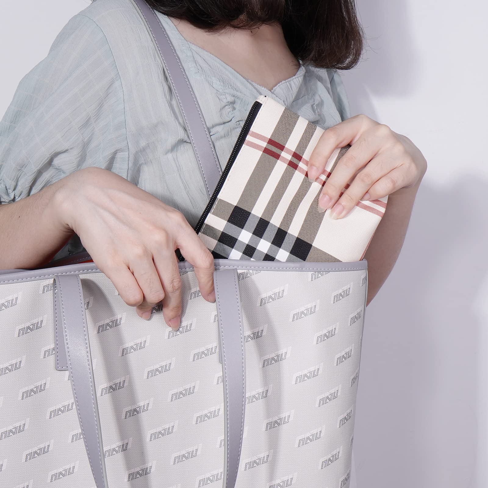 MAANGE khaki makeup bag carried by hand highlighting portability