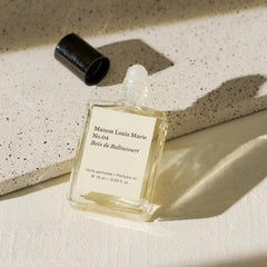 Maison Louis Marie No.04 Bois de Balincourt fragrance notes visual emphasizes sandalwood and amber for depth.