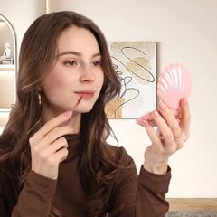 Maji Mama travel brush with built-in mirror, compact for quick checks.