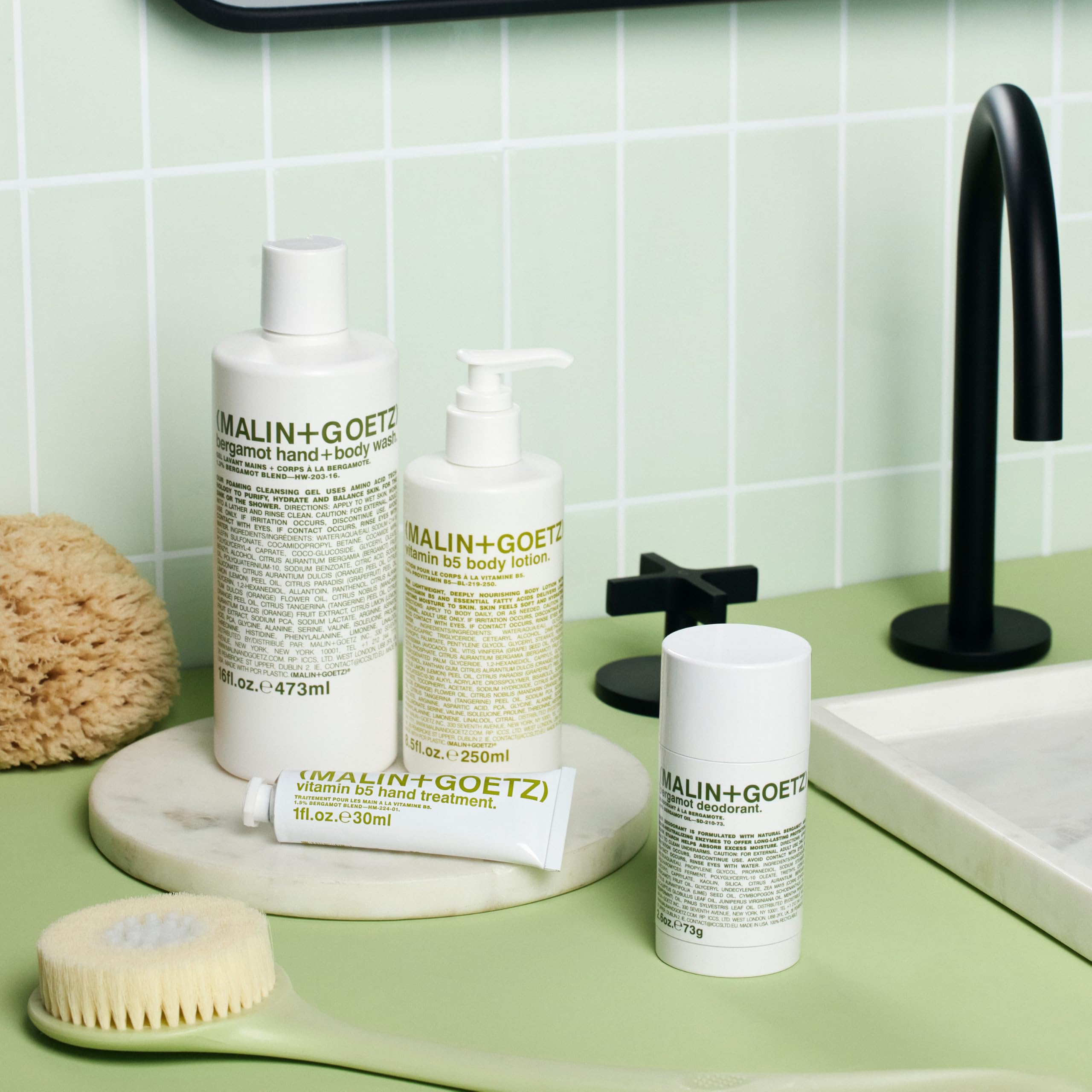 MALIN+GOETZ Vitamin B5 Body Lotion applied to arms and legs for even moisture.