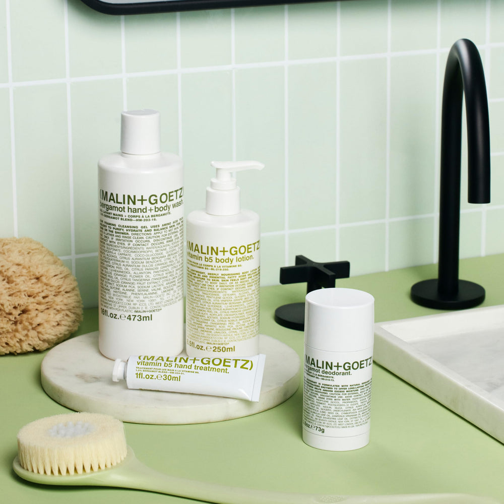 MALIN+GOETZ Vitamin B5 Body Lotion applied to arms and legs for even moisture.
