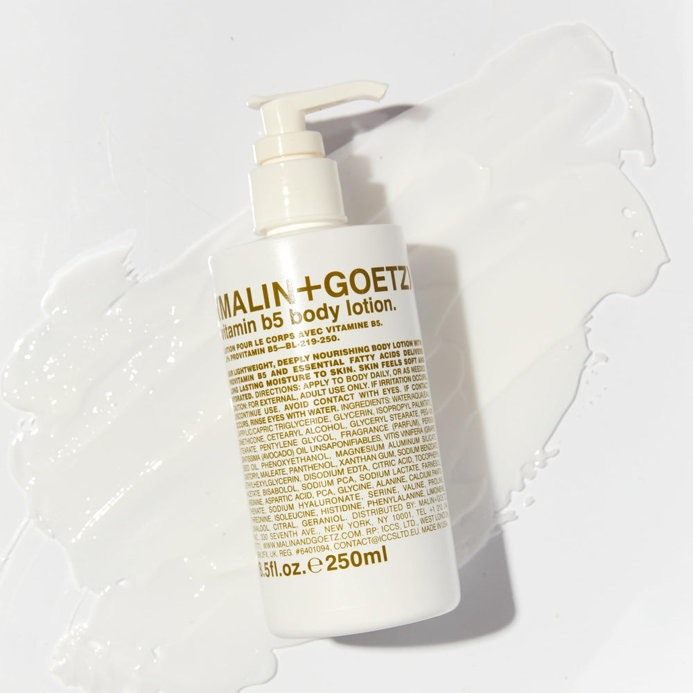 MALIN+GOETZ Vitamin B5 Body Lotion being applied to dry skin for moisture.