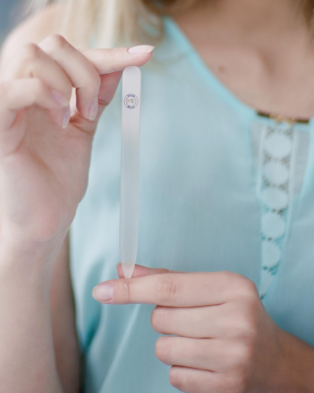 Nail file being rinsed under warm water for easy cleaning.