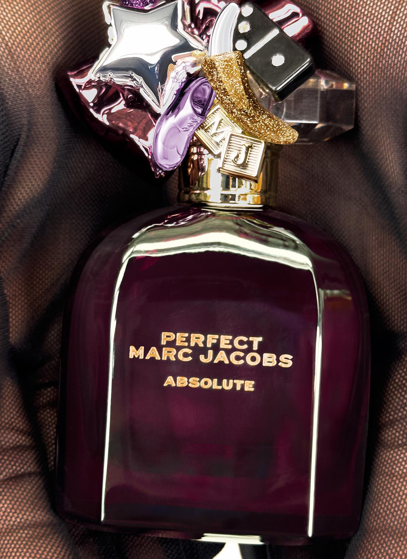 Marc Jacobs Perfect Absolute in hand, 1.6 oz bottle for on-the-go moments.
