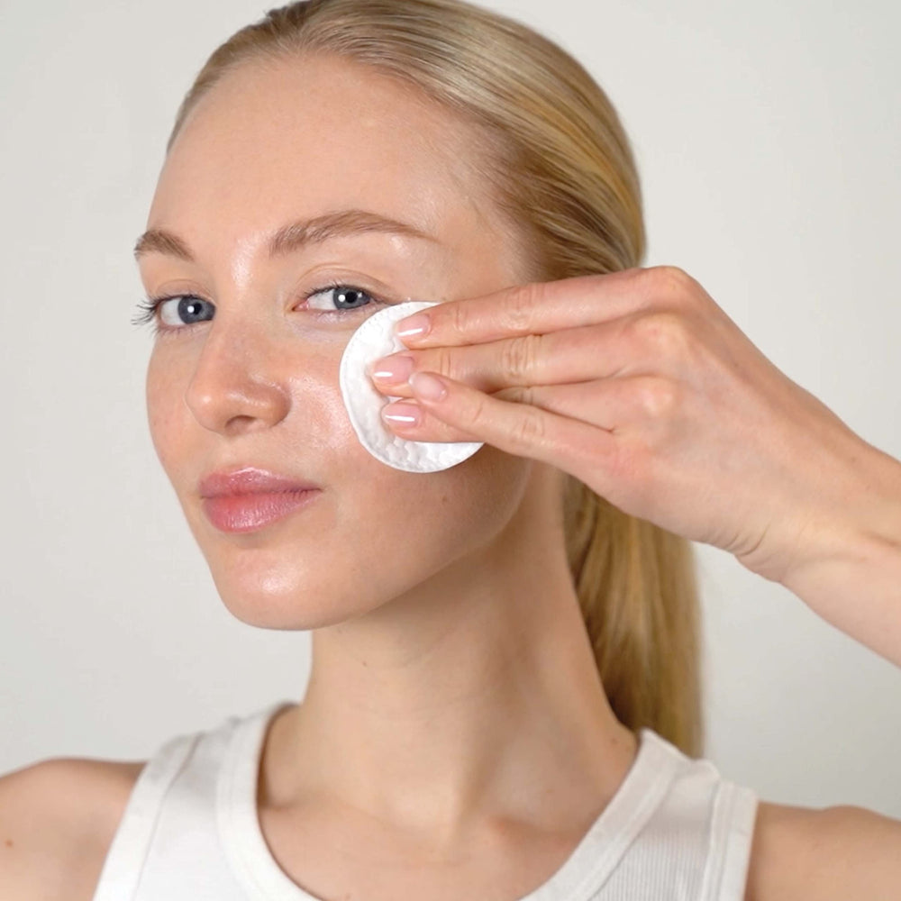 Close-up of Mario Badescu Glycolic Toner label emphasizing texture refinement.