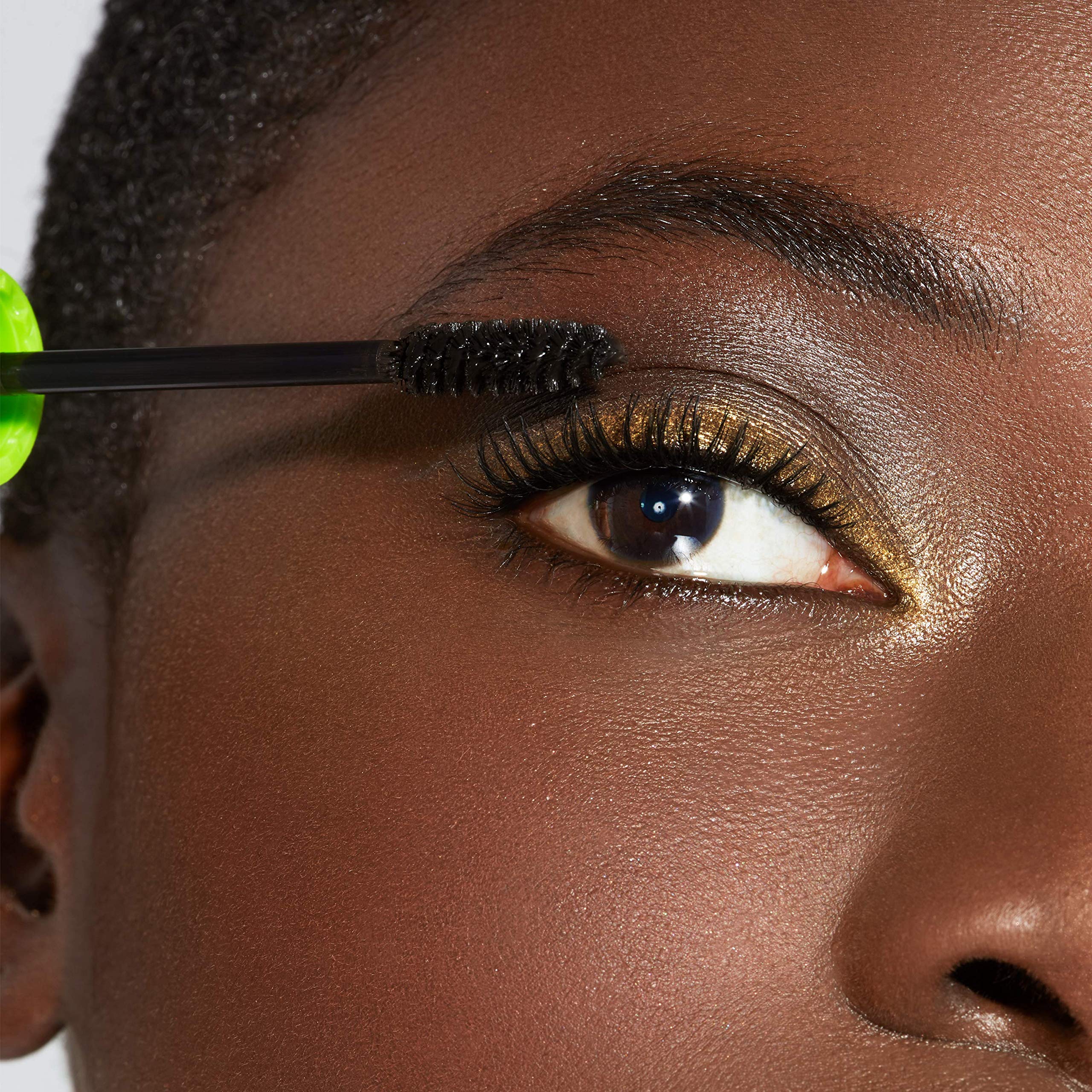 Applying Maybelline Great Lash mascara on upper lashes for curl and volume.