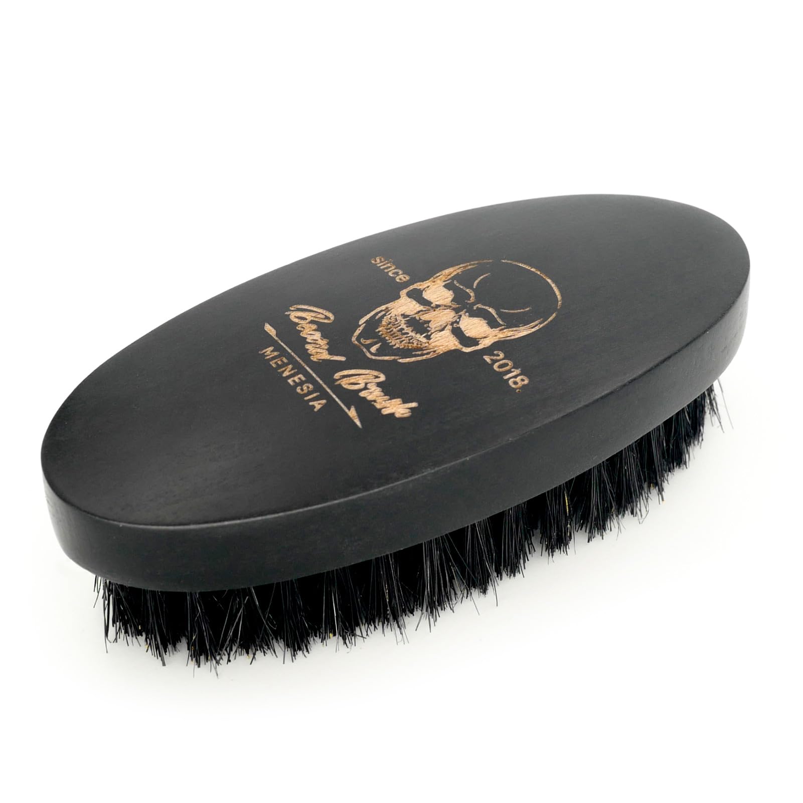 Menesia pocket-travel beard brush shown beside a phone for on-the-go grooming.