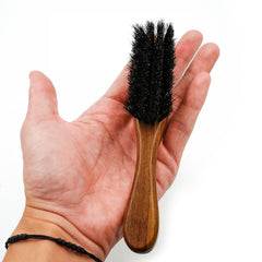 Menesia travel-friendly beard brush shown in compact pocket form.