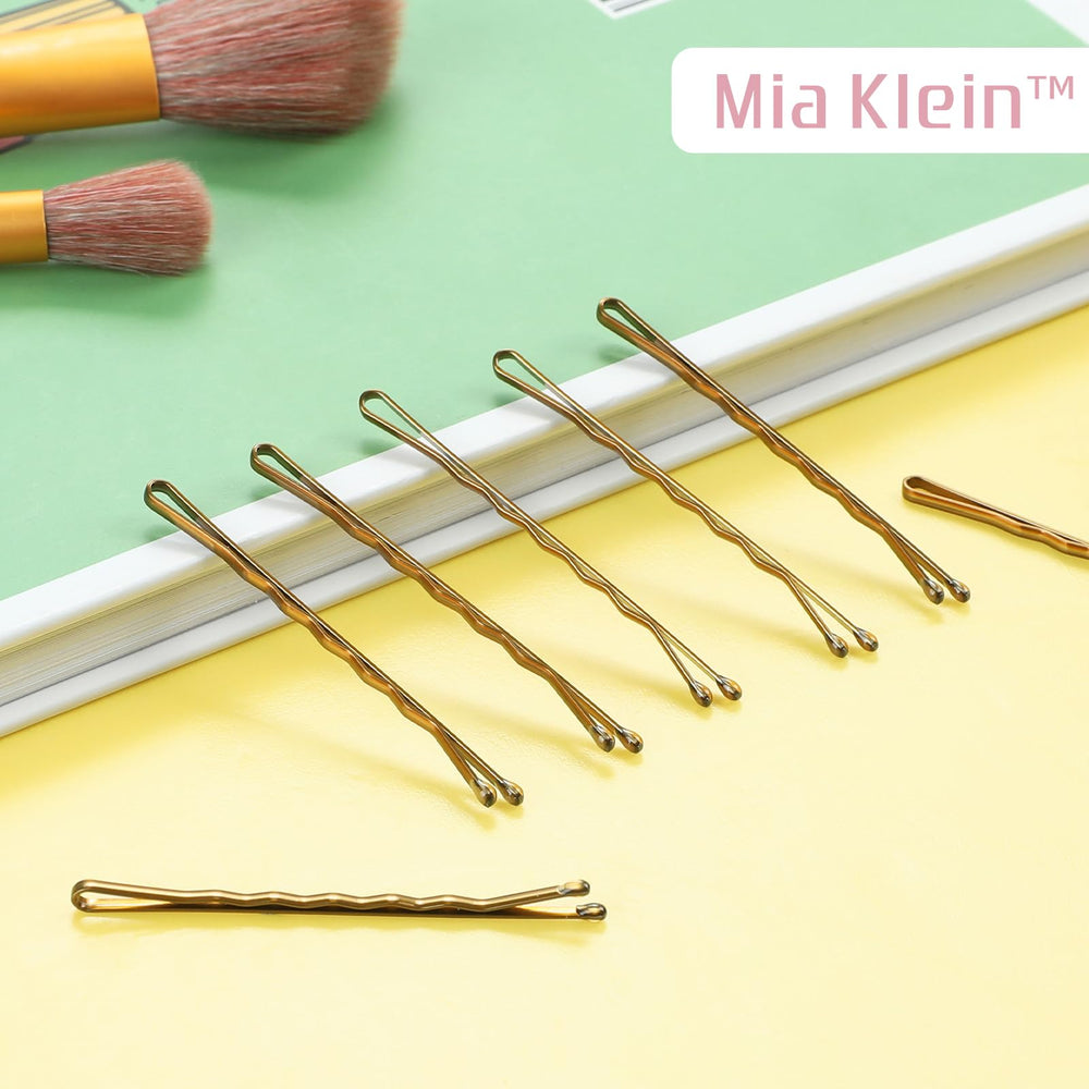 Mia Klein bobby pins in gold-blonde tones clip hair securely without slipping.
