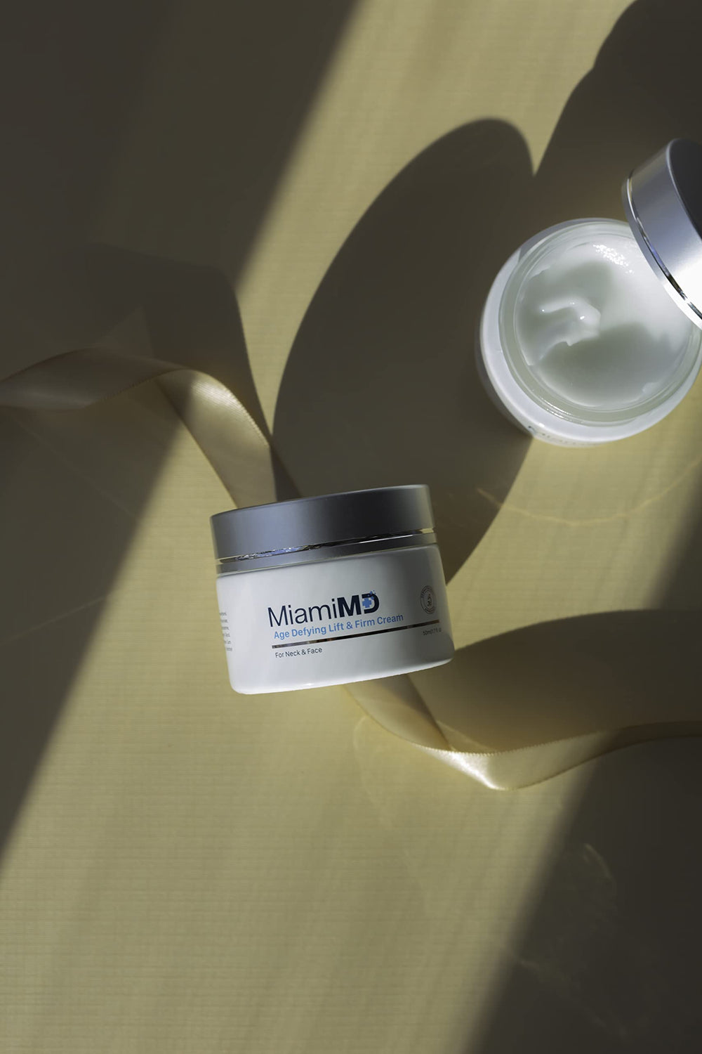 MiamiMD Age-Defying Lift & Firm Cream swatch shows rich, lightweight texture.
