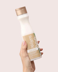 Milagros Herbal Conditioner bottle delivers soft, detangled hair with shine.