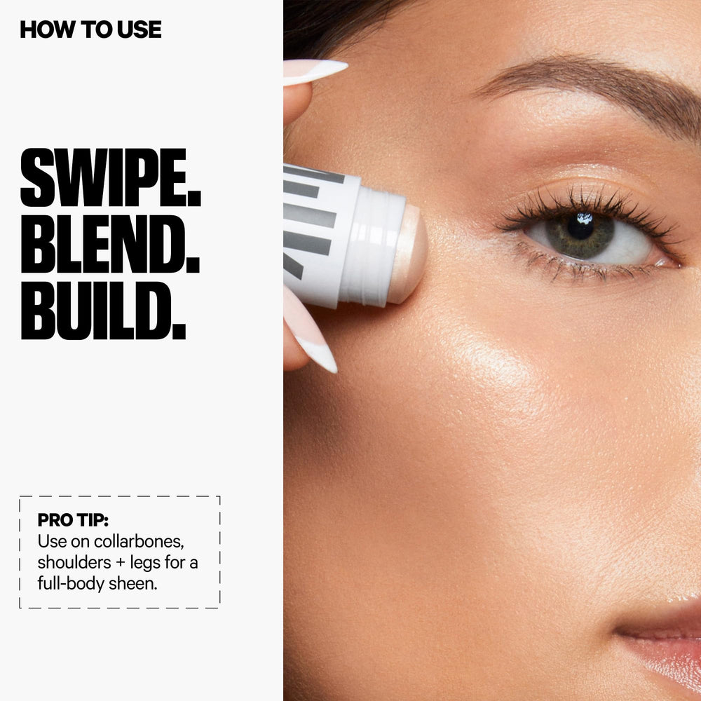Milk Makeup Lit highlighter stick on decolletage for luminous neckline.