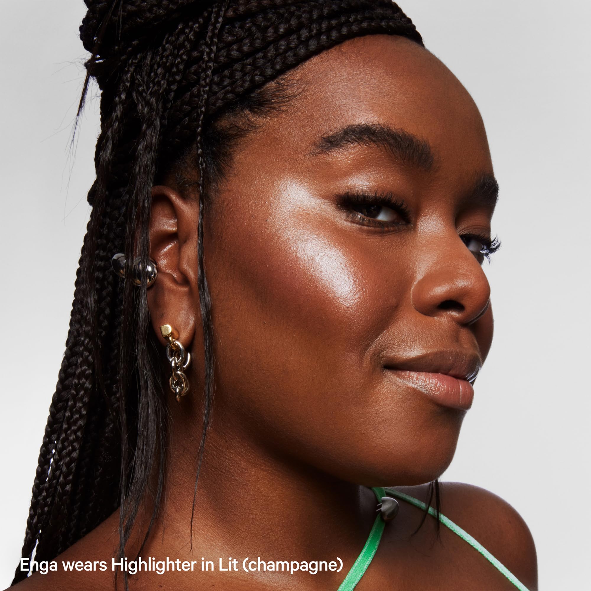 Milk Makeup Lit highlighter stick on forearms for day-to-night shimmer.