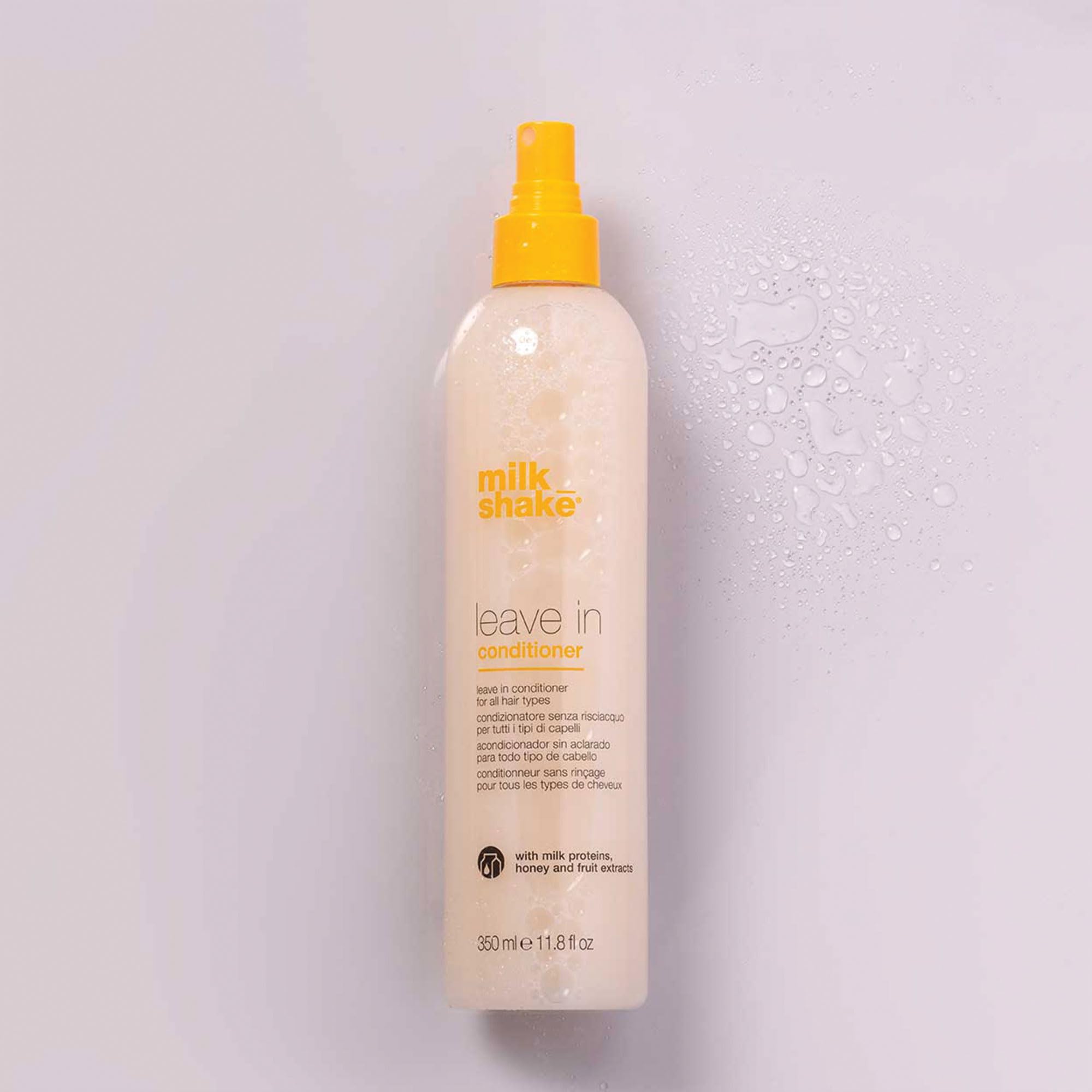 Milkshake Leave-In Detangler Spray on tangled hair to reveal easier styling and soft finish.
