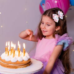 Miroksh 4-inch birthday bow worn in hairstyle for celebration