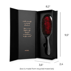Misel brush gliding through hair for smooth styling.