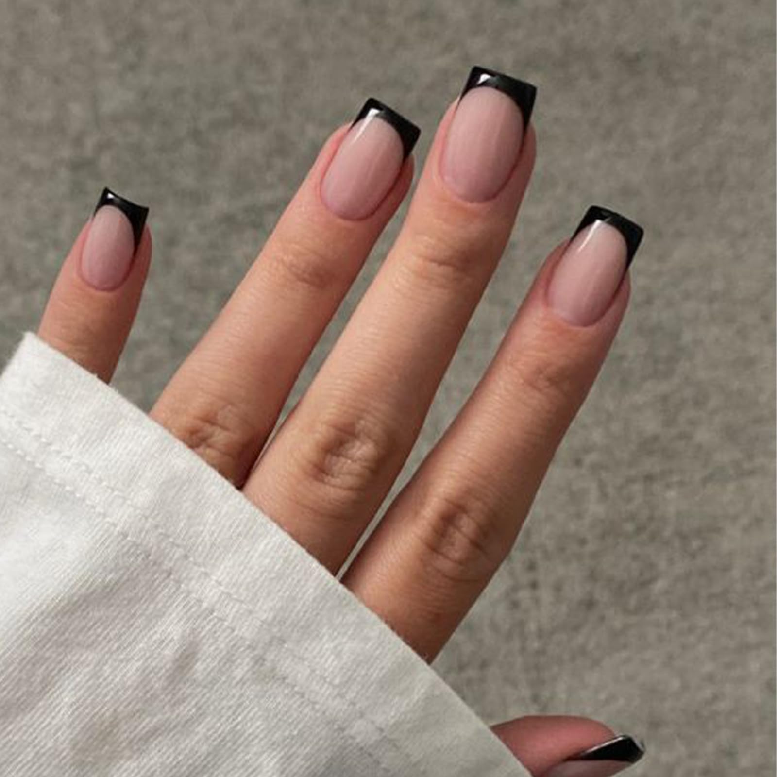 Modelones Black French Tip press-on nails in a short square shape for a quick, stylish manicure.