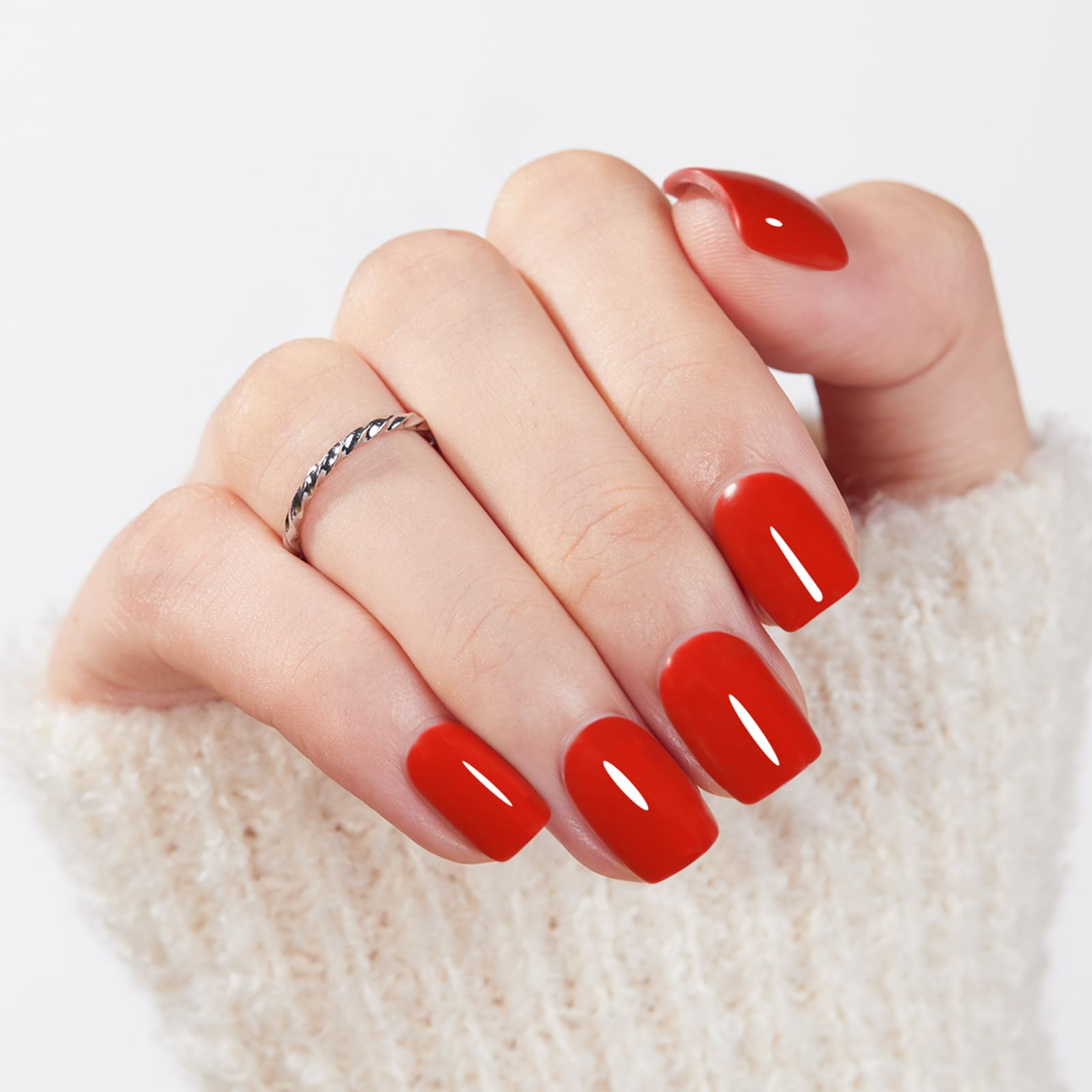 Modelones close-up of red squoval nails highlighting at-home application.