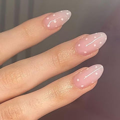 Modelones uñas postizas rosadas en almendra con puntos, ideal para estilos versátiles.