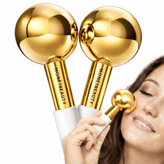 MonétBeauty stainless steel ice globes in gold on the face for cooling and pore tightening.