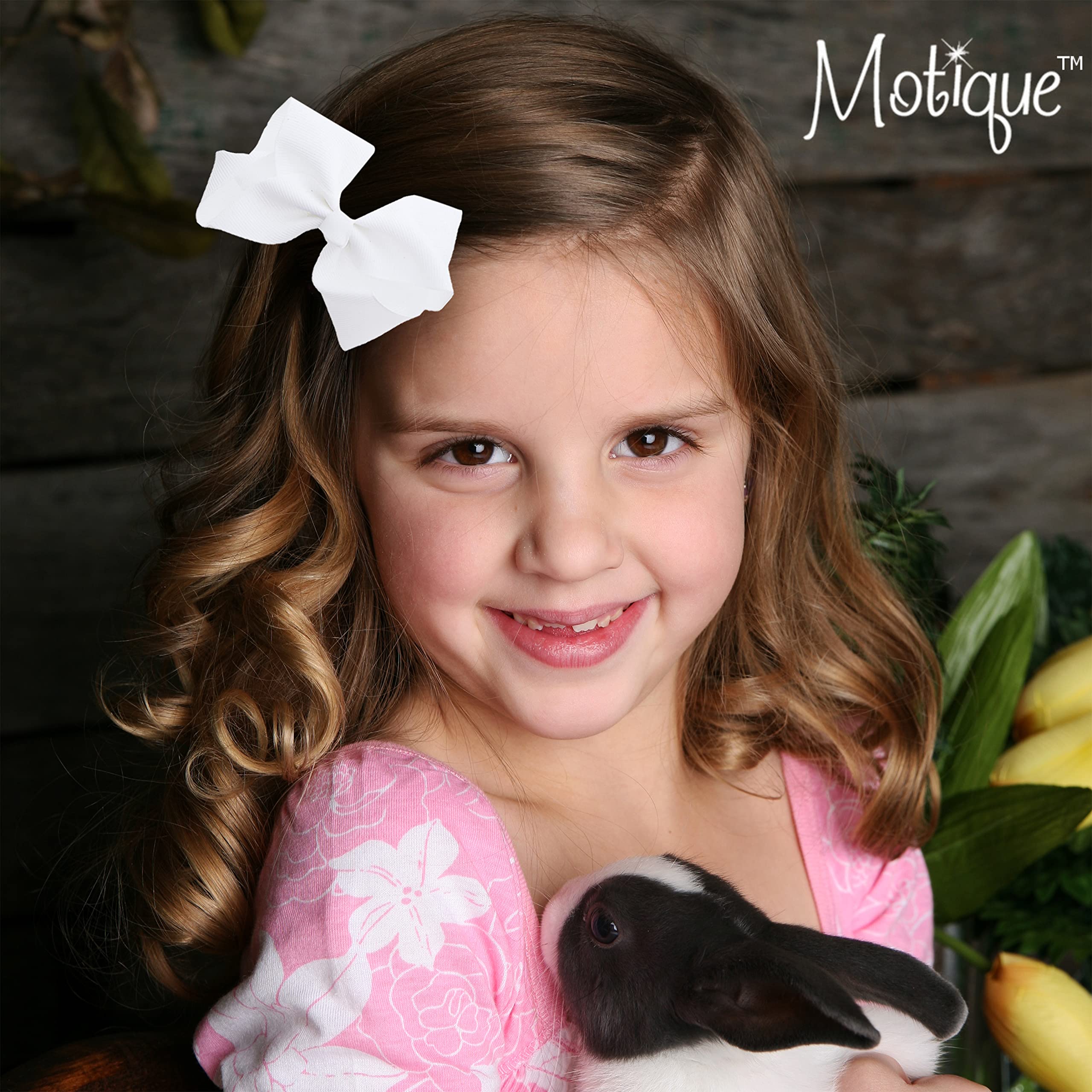 Motique black bow complements school and party looks.