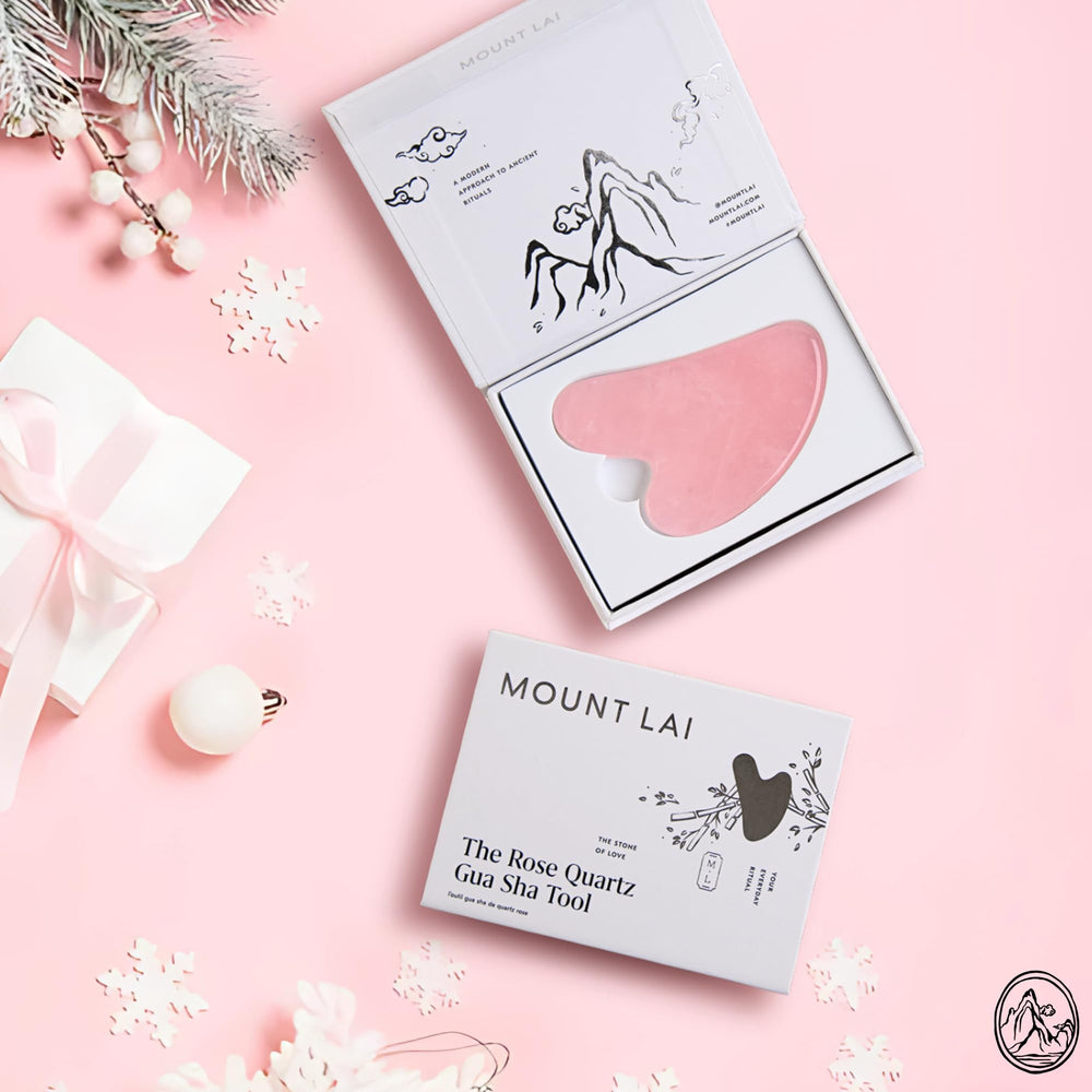 Mount Lai Rose Quartz Gua Sha on cheeks with outward massage supporting gentle lymphatic drainage