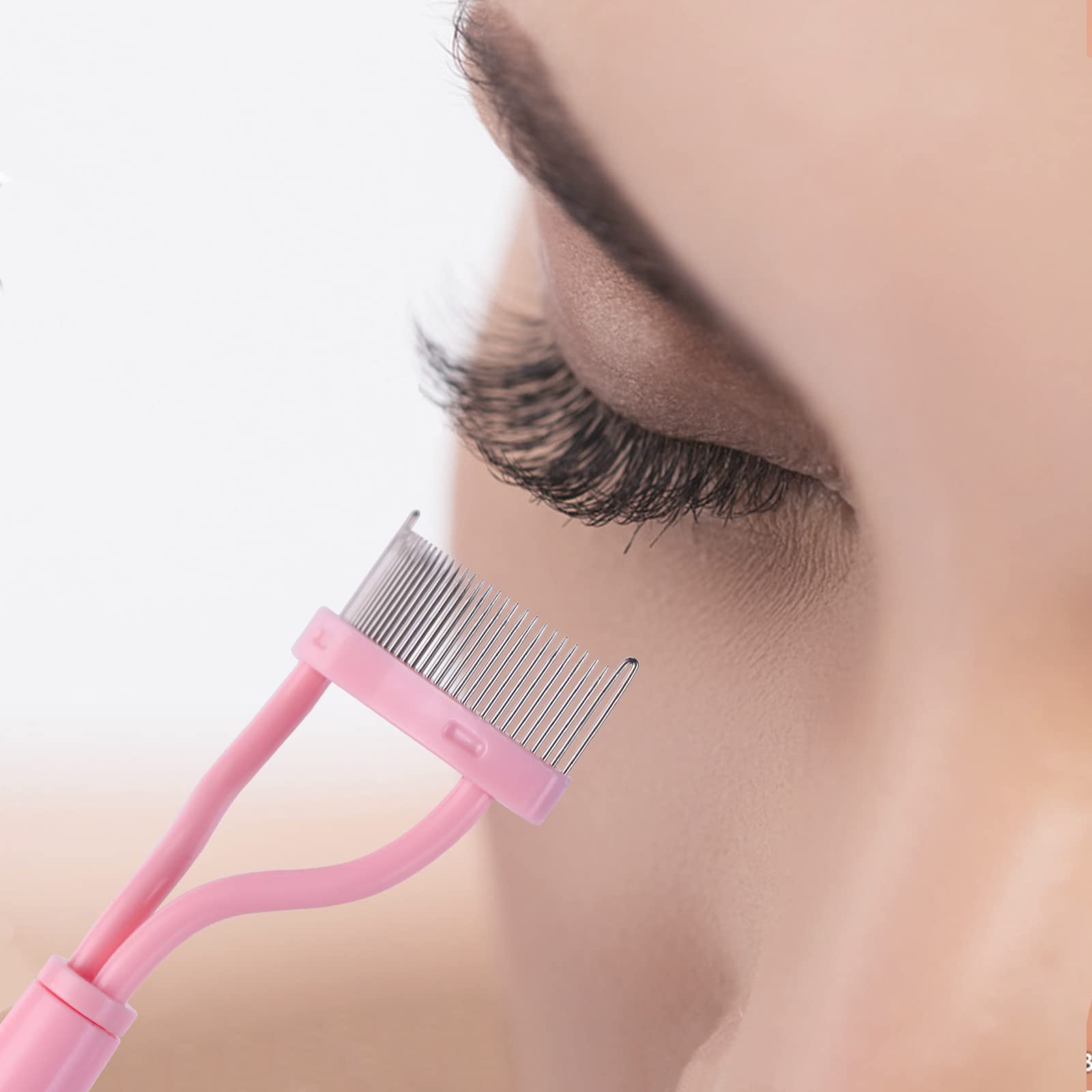MSQ stainless steel comb gliding through lashes for a clean finish