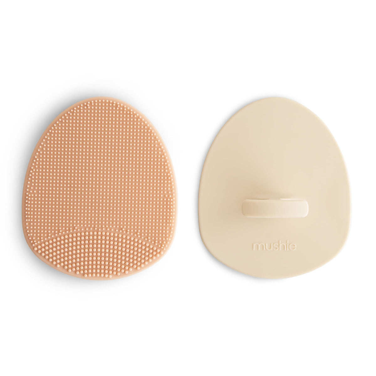 Mushie cepillo costra craneal con agarre ergonómico para baño cómodo.