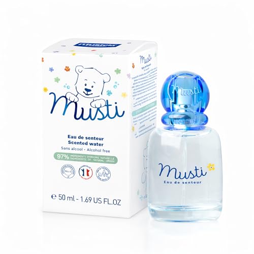 Mustela Musti baby spray application shows easy daily fragrance for newborns.