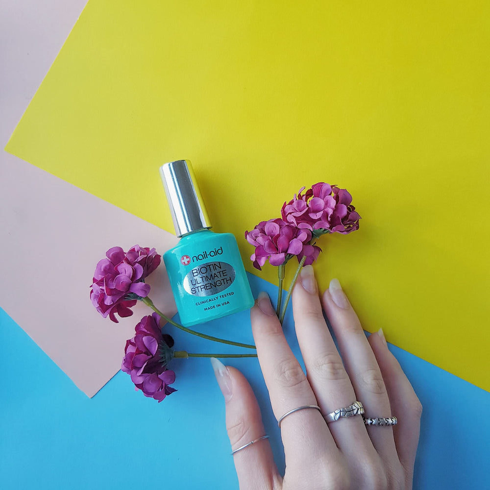 Nail-Aid Biotin Ultimate Strength base and top coat in use for color protection.