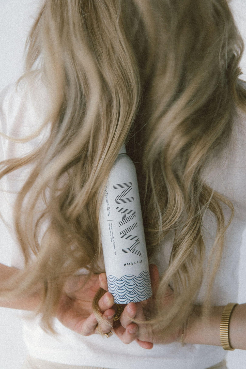 Navy Hair Care Navy Dry Texture Spray before-styling bun adds extra volume