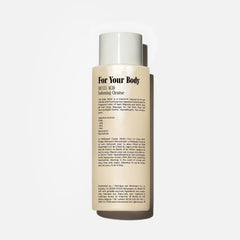 Close-up of Nécessaire Hinoki body wash foaming into a rich lather