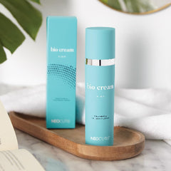NEOCUTIS Bio Cream Firm tube on hand during application demonstrating neck and face smoothing