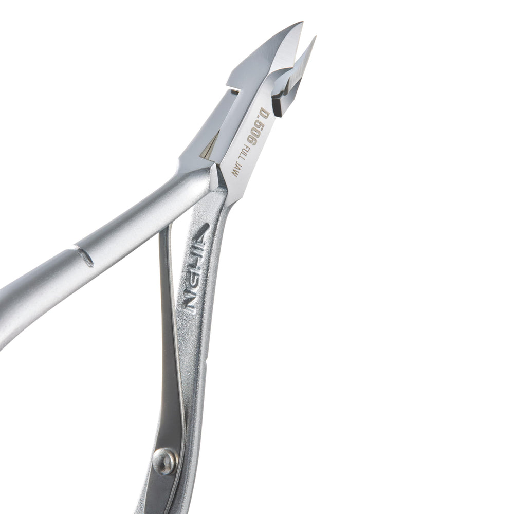 Nghia premium hard steel cuticle nipper in salon setting for precise work.