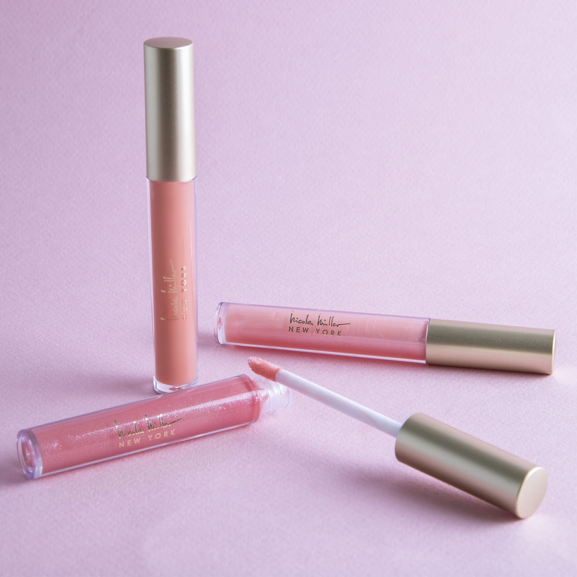Nicole Miller brillo labial en estuche elegante para llevar en bolso.
