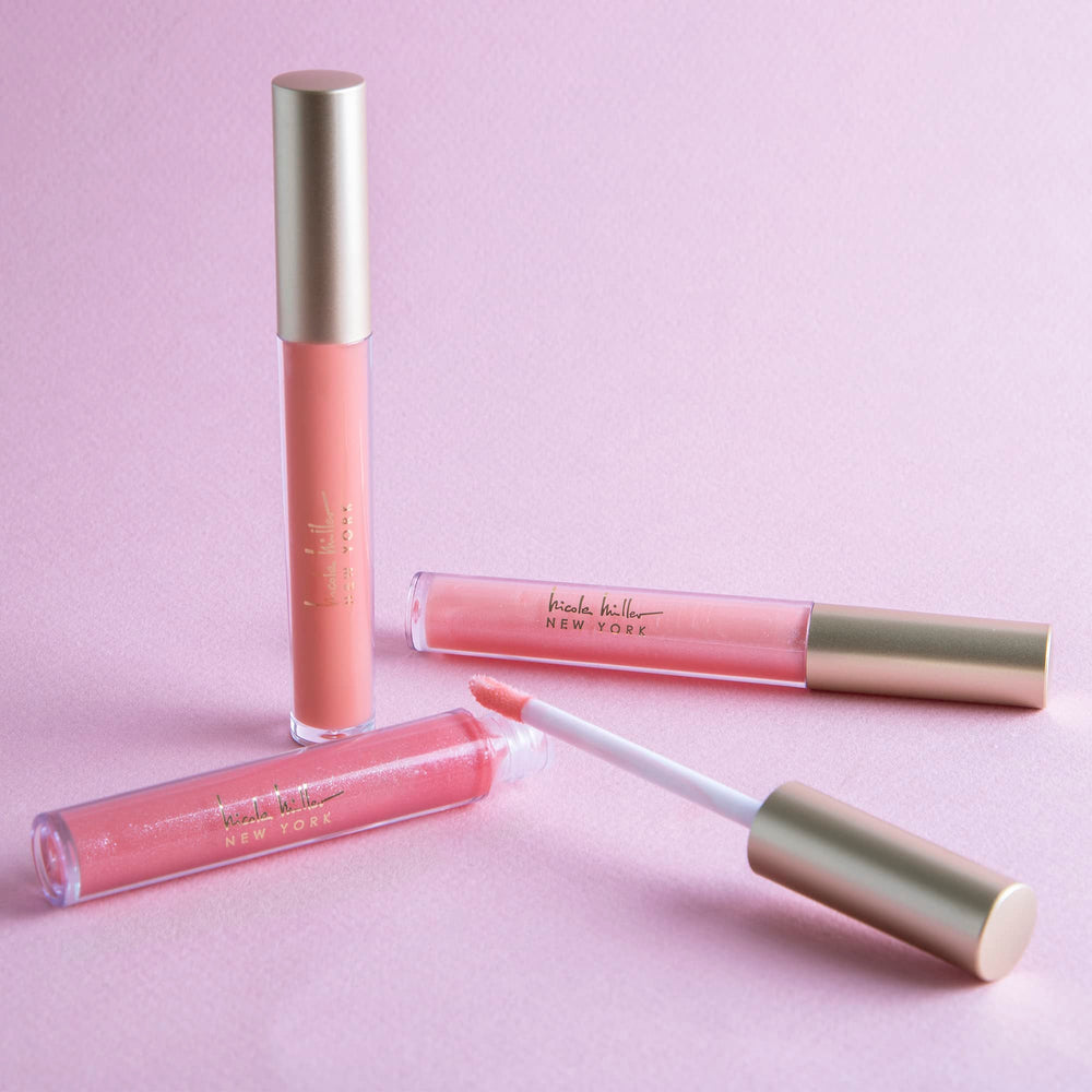 Nicole Miller brillo labial en estuche elegante para llevar en bolso.