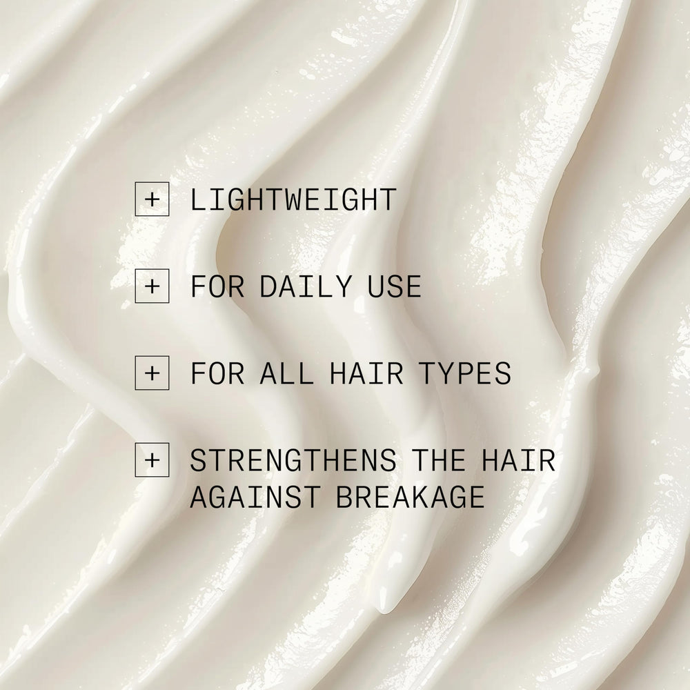 Close-up of NIOXIN Age Defense Conditioner on hair for manageability.