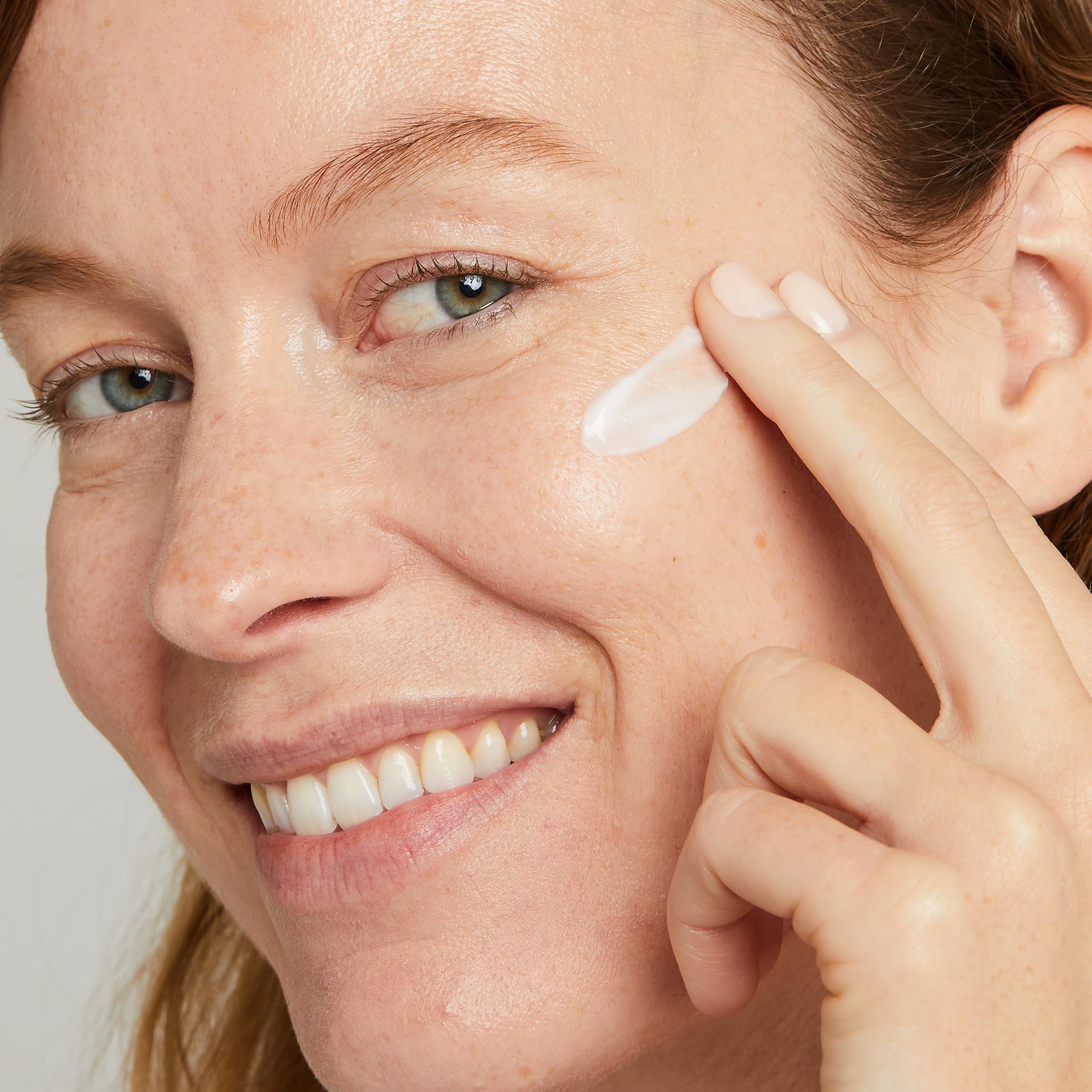 No7 Lift & Luminate night cream application on skin suggests overnight hydration.