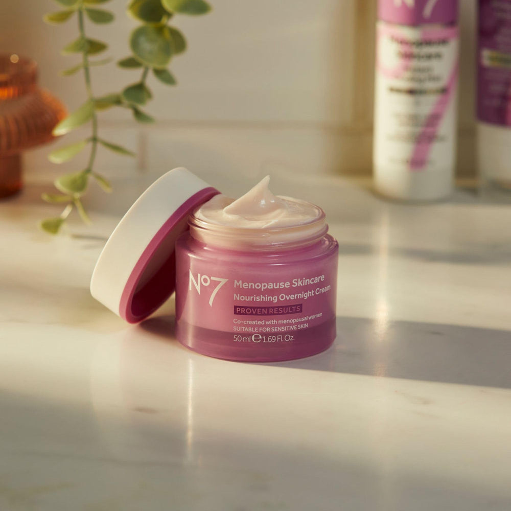 Hand applying No7 night cream to the face for overnight moisturization.