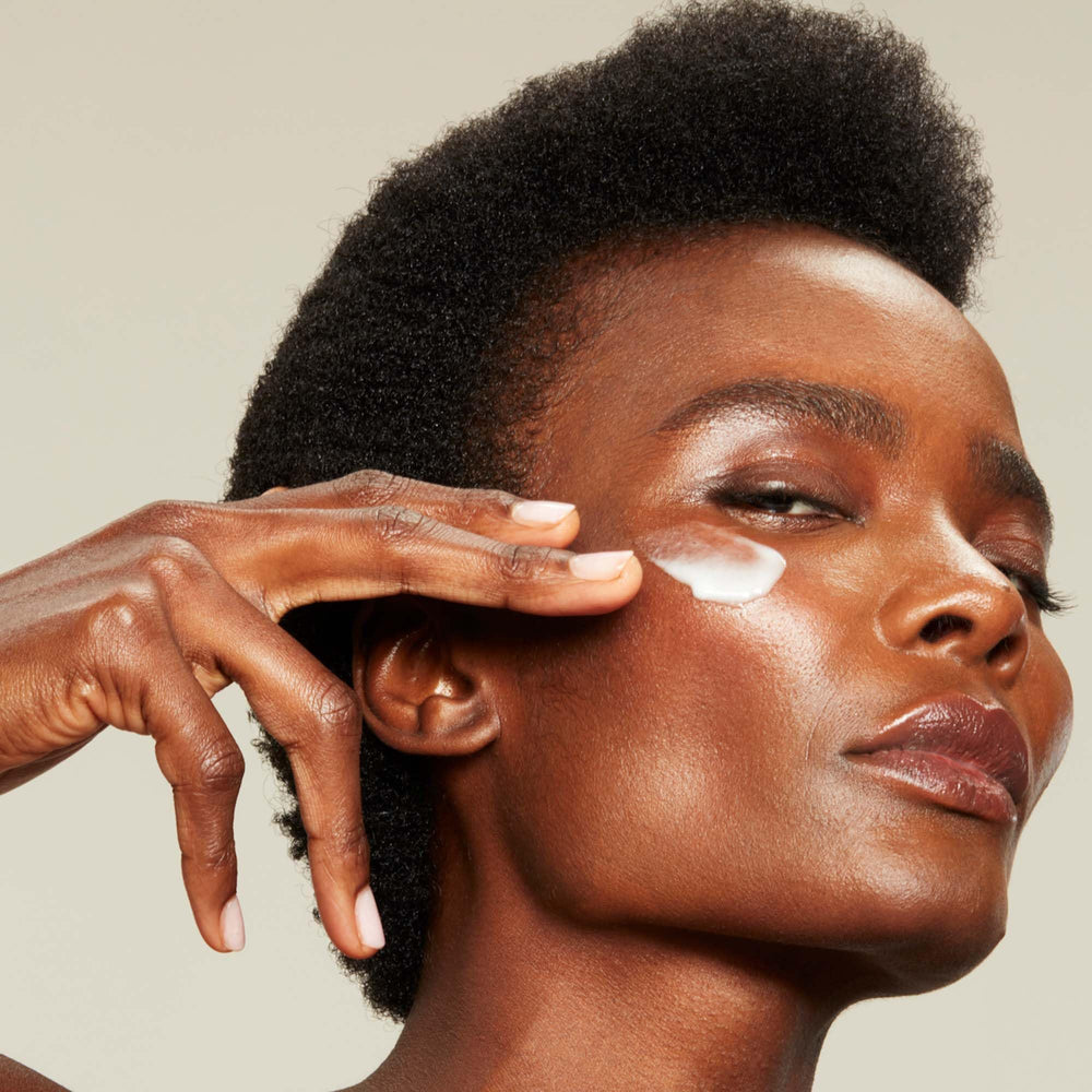 NuFACE Silk Creme Activator applied in sections along cheeks, neck, and forehead surface.