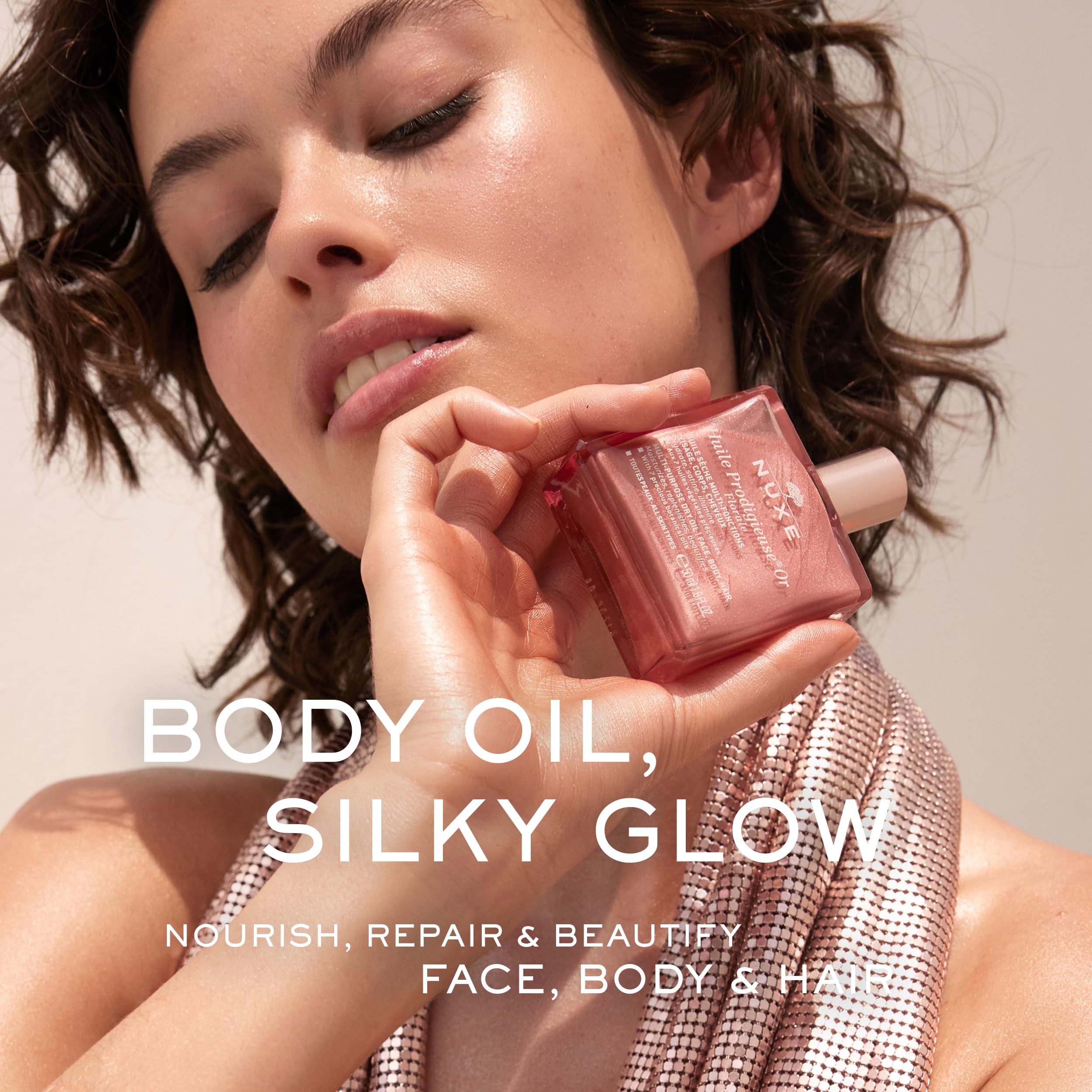 Nuxe Huile Prodigieuse Florale rose-gold glow swirls on skin
