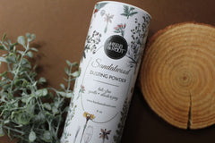 Herb & Root oats-infused soothing powder in application on skin.